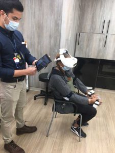 Senior in VR headset sitting down