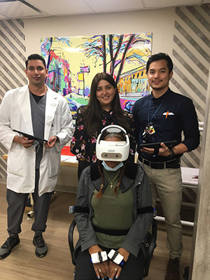 Faculty and resident pose with VR headset