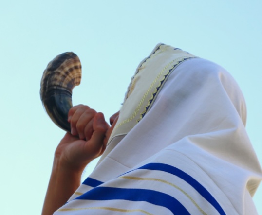 person blowing the shofar