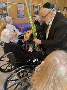 Rabbi talking to senior for Sukkoth
