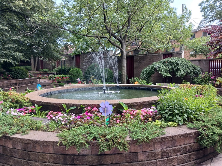 A fountain surrounded by beautiful flowers