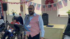 A senior living community celebrates a patriotic event with decorations, music, and engaging activities for its wheelchair-bound residents, creating a warm and inclusive atmosphere