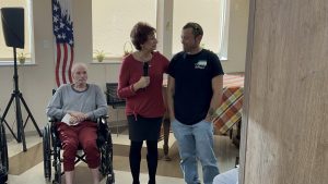 Iraqi war veteran Chris Goldberg is thanked by Linda Spiegel beside Joel Zamisky