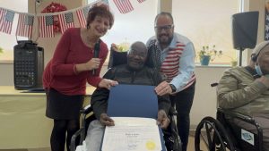 U.S. Army veteran Willie Canon receives a NYS Assembly Citation from Linda Spiegel and Ricardo Sola.